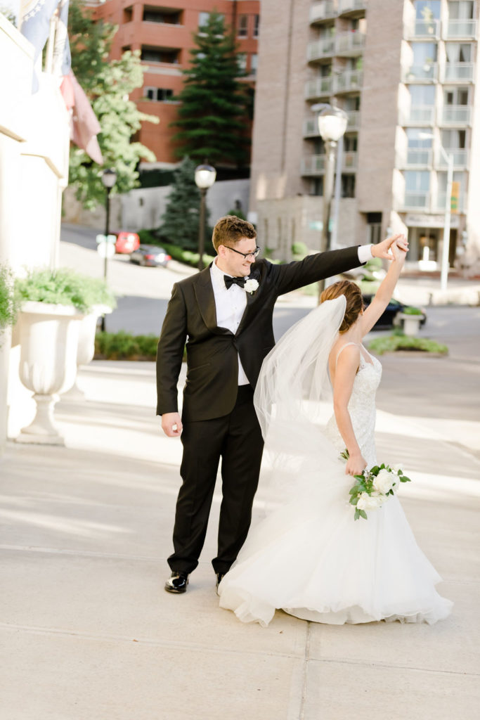 Bride + Groom on the Country Club Plaza Captured by Laura Foote Photography | Floral by Blue Bouquet | Kansas City Florist, Midwest Florist | Wedding at The Intercontinental Hotel, Wedding at Loose Park Rose Garden