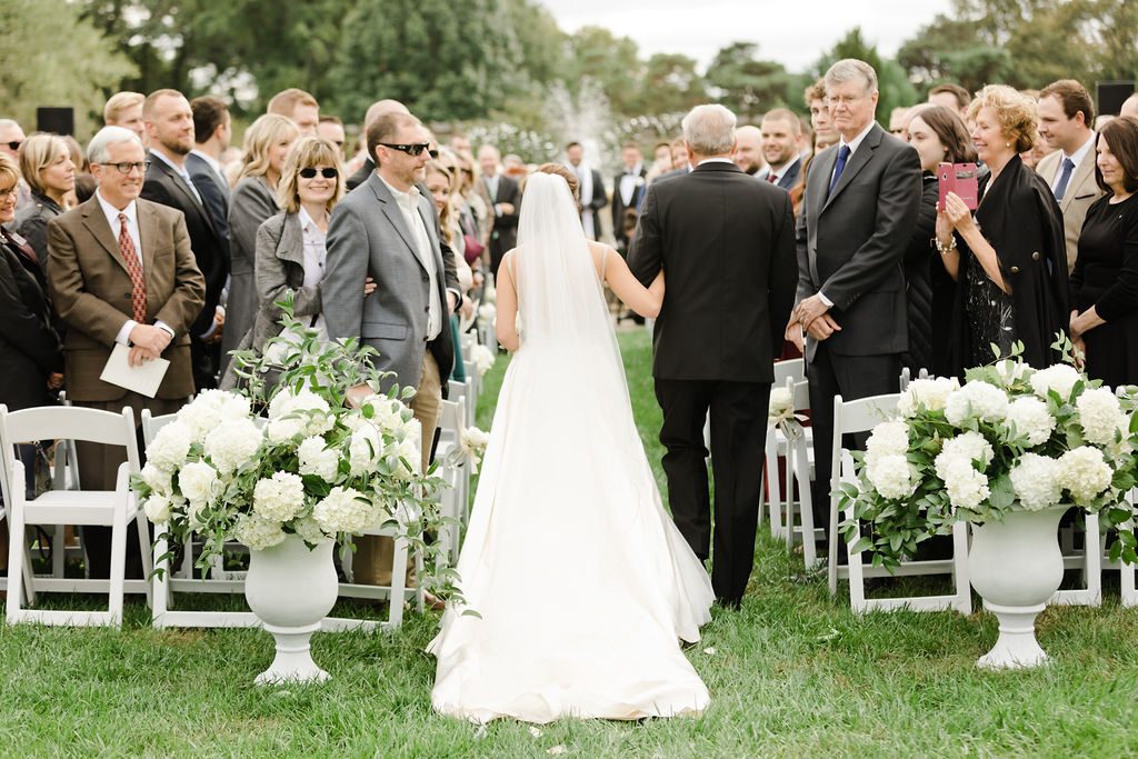 Bride Walking Down the Aisle with her Father Captured by Laura Foote Photography | Floral by Blue Bouquet | Kansas City Florist, Midwest Florist | Wedding at The Intercontinental Hotel, Wedding at Loose Park Rose Garden