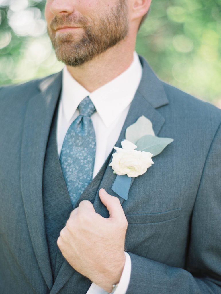 Groom in Tux with Boutonniere by Blue Bouquet