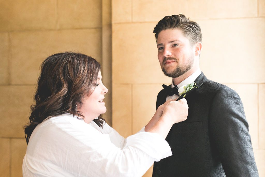 The Groom + His Mother Pinning on his Boutonniere | Floral by Blue Bouquet at The Grand Hall at Power & Light