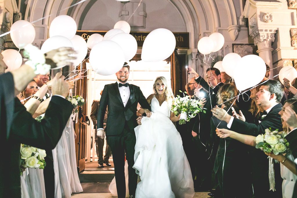 Balloon Exit After the Ceremony at Country Club Christian Church in Kansas City | Floral by Blue Bouquet at The Grand Hall at Power & Light